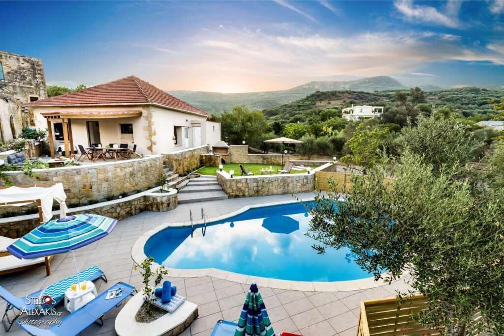 villa backyard with pool and sunbeds
